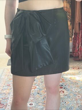 Black faux leather skirt with big bow on the front